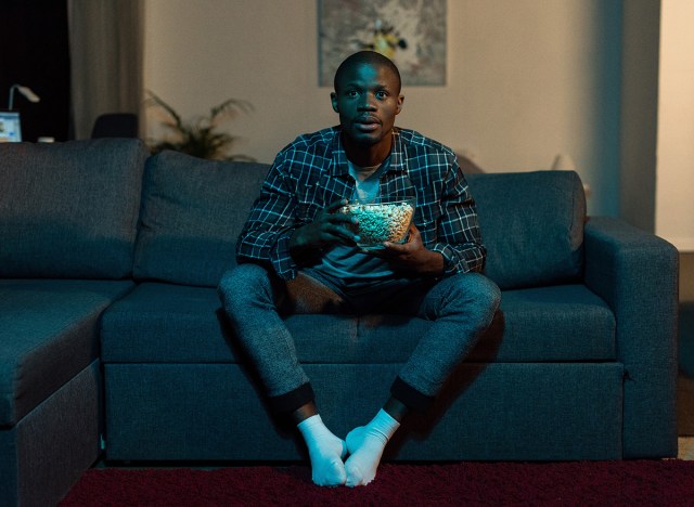 40 suggestions for males who need to lose weight after 40 231 man watching tv on couch holding popcorn bowl