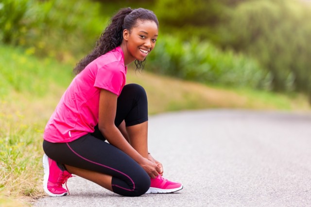 woman runner tightening shoe lace