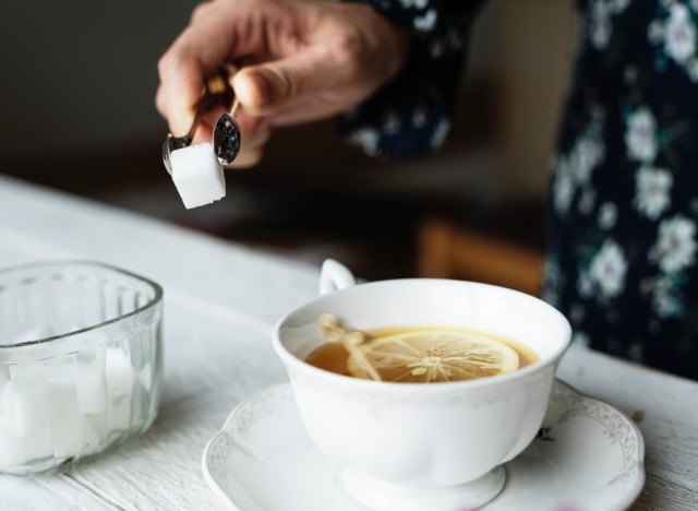 adding sugar to tea