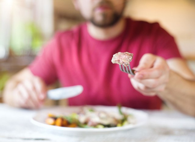 man cutting food