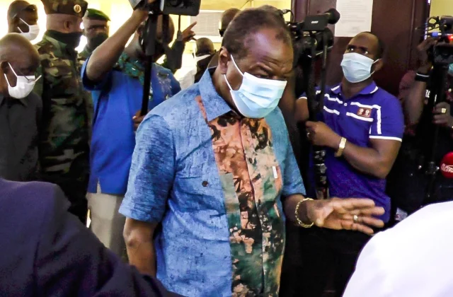 President Alpha Condé at the bedside for victims of post-election violence