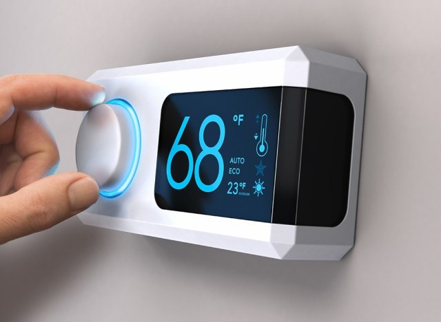 Woman setting thermostat - how to lose weight overnight