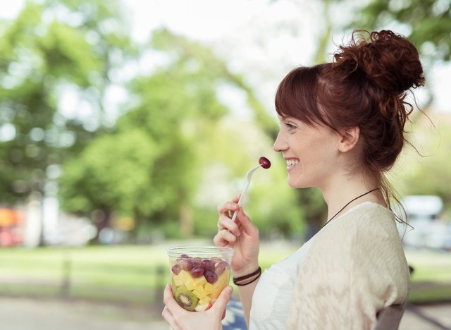 woman talking on fruit