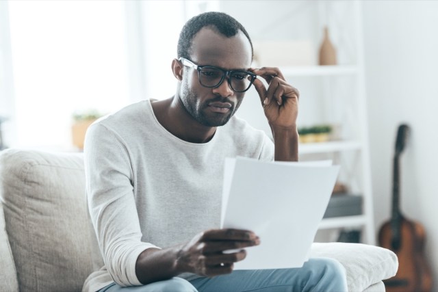 you read documents and touch glasses with your hand while sitting on the couch at home