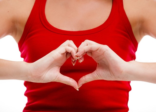 woman making heart shape with hands