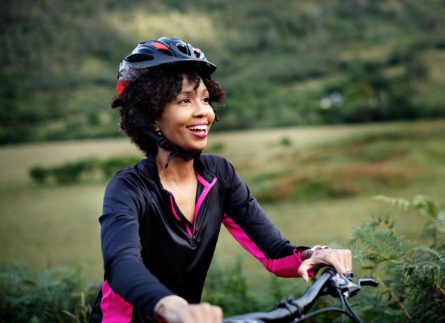 cheerful female cyclist enjoying a bike ride