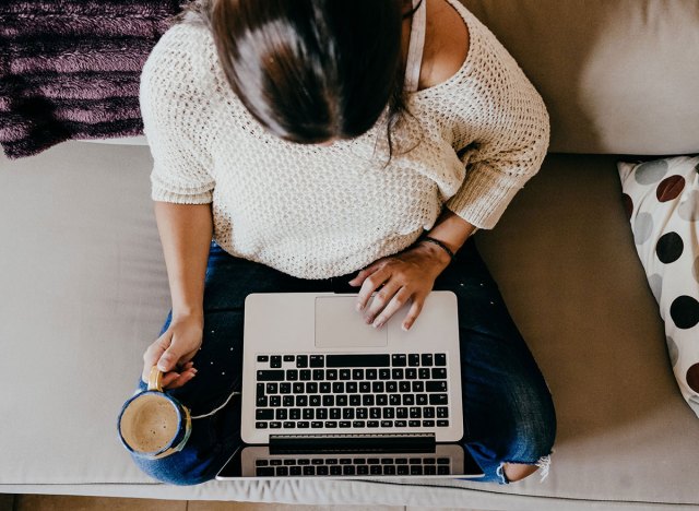 woman on computer drinking coffee