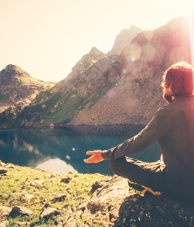 man meditating outdoors