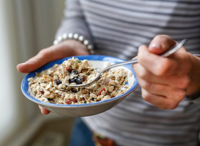 woman eating a bowl of oatmeal