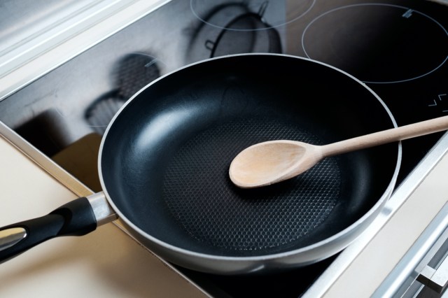 drip pan, wood spoon and black induction cooker