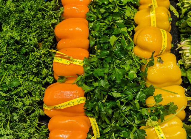 organic orange and yellow peppers in grocery store