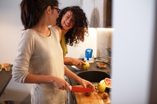 female friends in the kitchen preparing vegetarian meal together