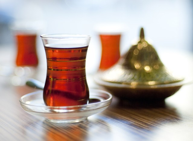 glass of black tea with tea infusion unit