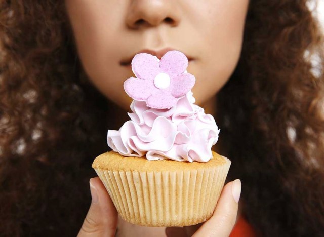 woman holding cupcake