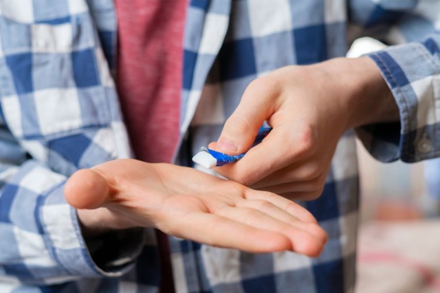 persons hand take chewing gum