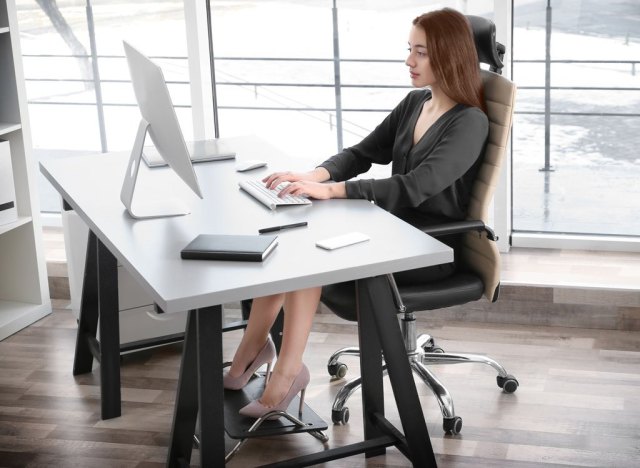 woman sitting at desk upright good posture