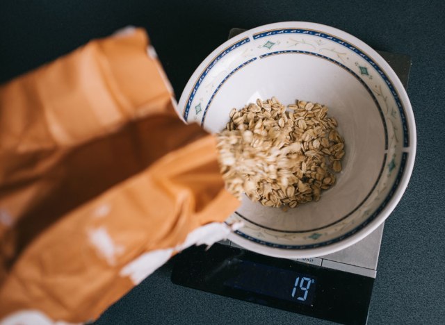 pouring oats into bowl to measure portion on scale