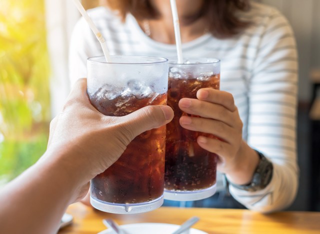 man and woman drinking soda in a restaurant