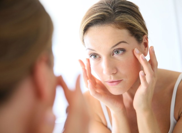 woman looking in mirror