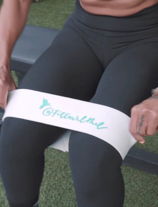 woman in black training pants and white thigh band