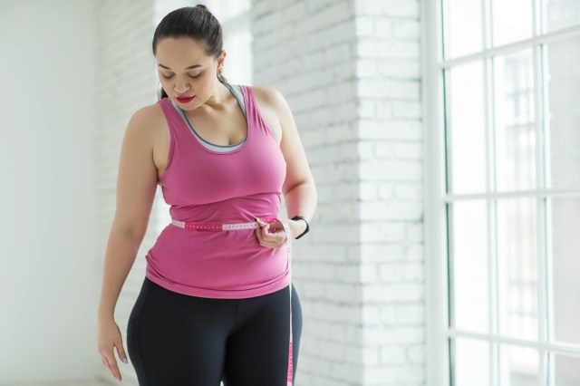 overweight woman checking the scale