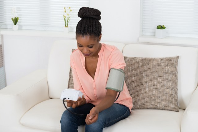 woman checking blood pressure at home