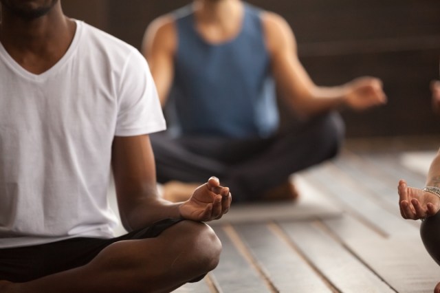 three people in meditation course