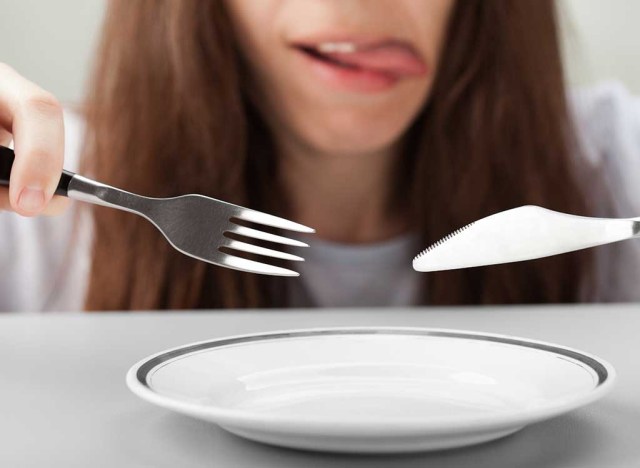 hungry woman fork knife empty plate