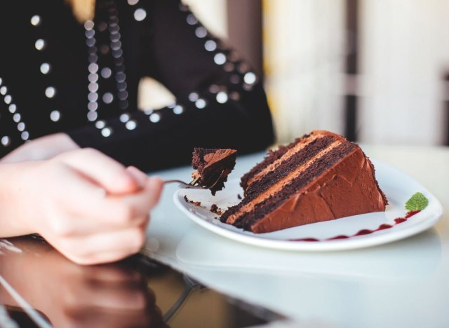 woman eating chocolate cake