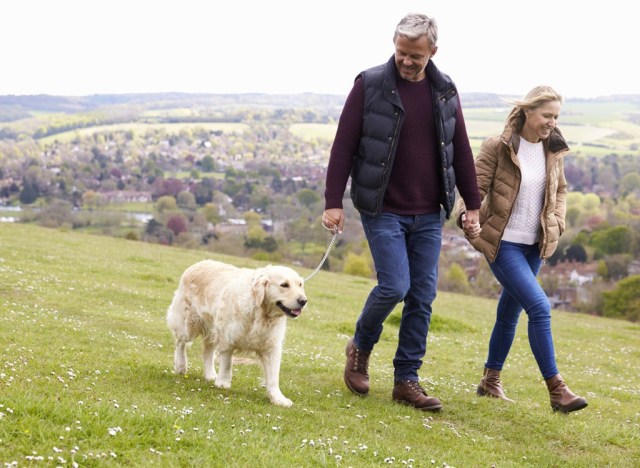 couple walking dog