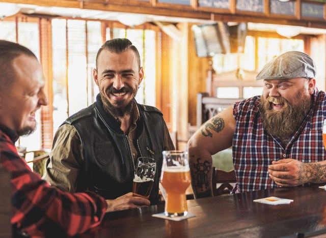 men and boys drinking beer in a bar