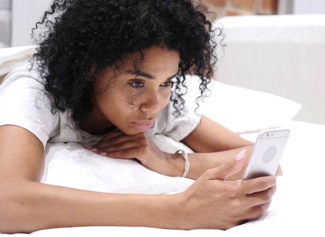 woman on the phone in bed