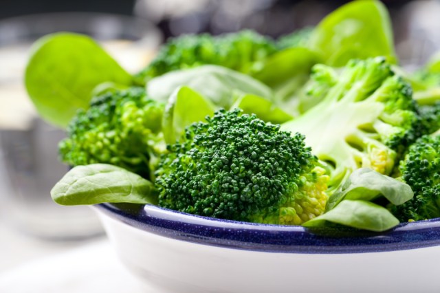 broccoli, baby spinach and green beans salad in ceramic bowl