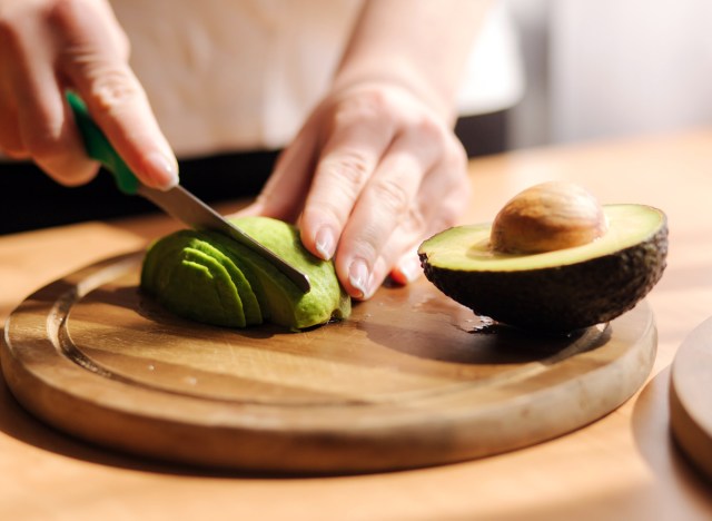 woman slicing avocado