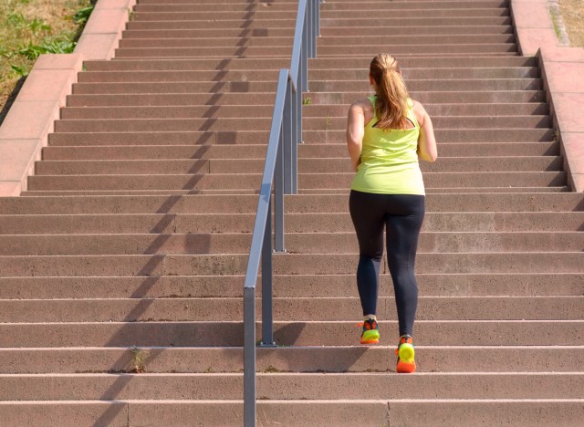 woman walking up the stairs to exercise