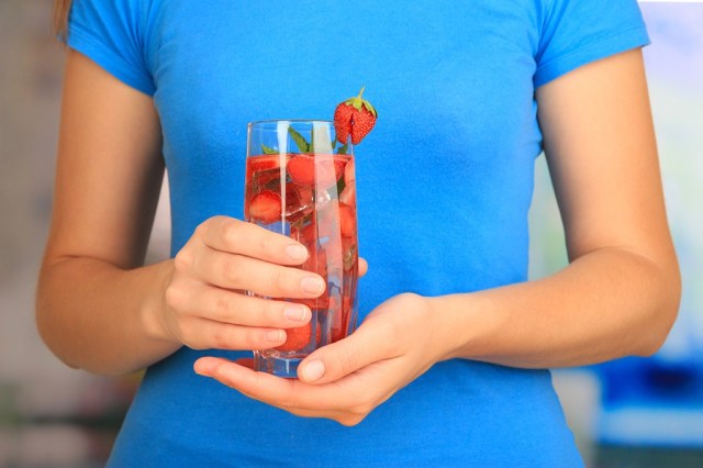 woman holding fruit water