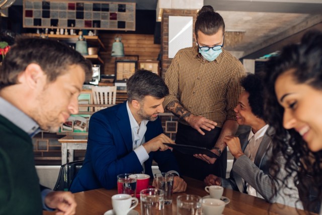 group of business people ordering their meal at the restaurant.