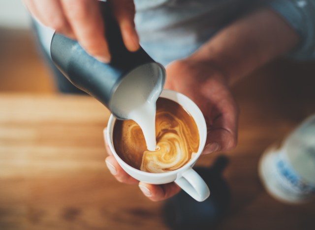 man barista making coffee latte