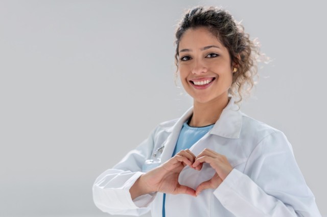 happy doctor making a heart shape and smiling