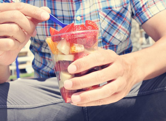 man eating fruit