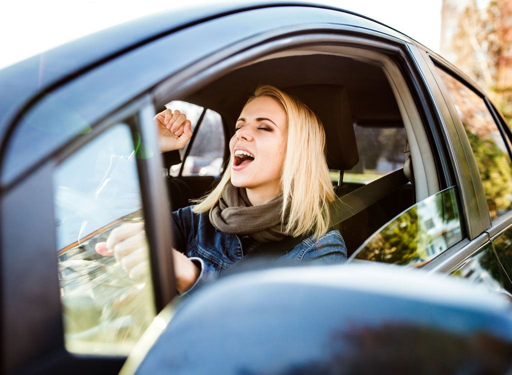 woman singing in car