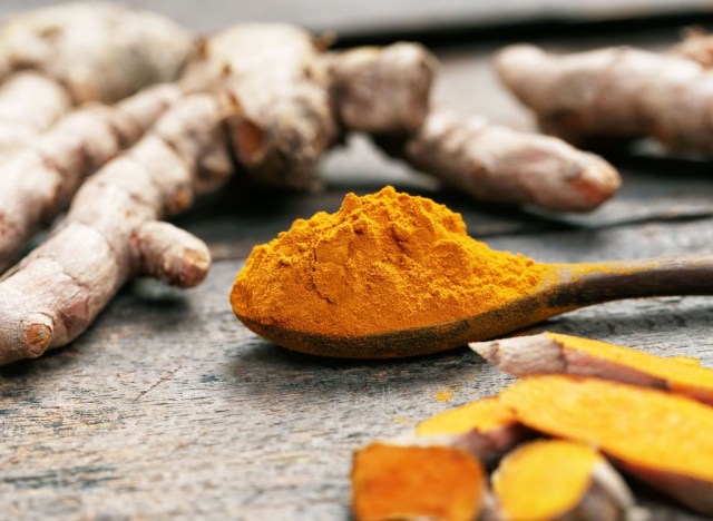 turmeric powder on wooden spoon