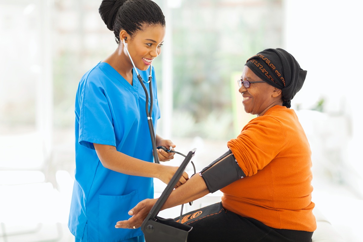 nurse checking the woman's blood pressure