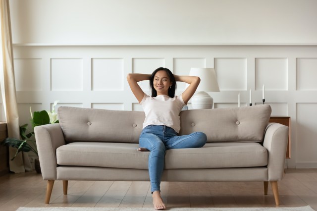 happy woman sitting on a sofa