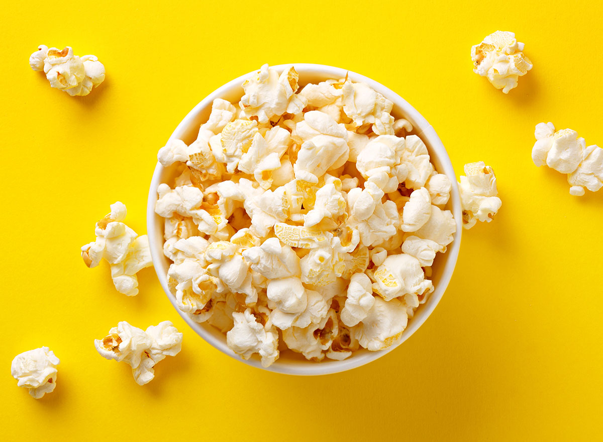 cup of popcorn against yellow background