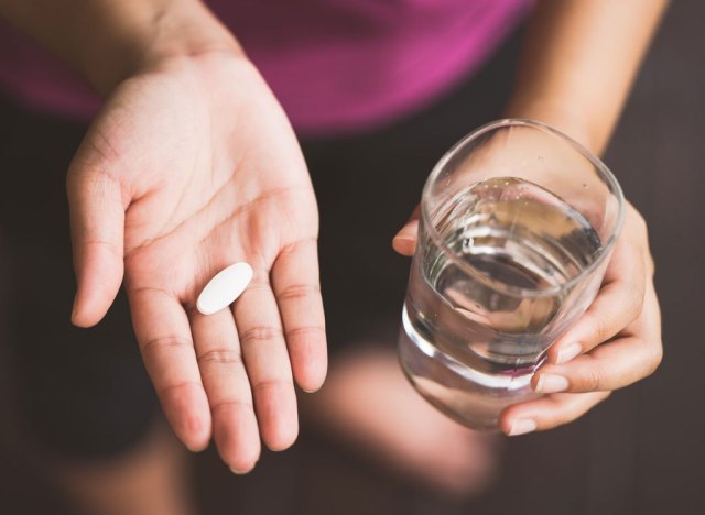 woman taking pill