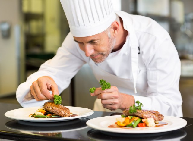 chef placing meal on dish