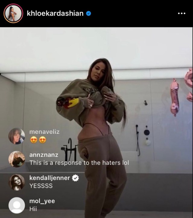 still from instagram live where khloe kardashian raises her shirt to reveal her belly