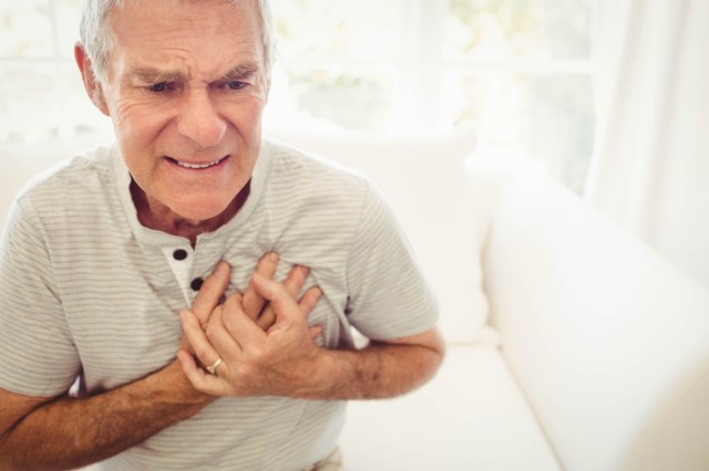 senior man with pain on heart in bedroom