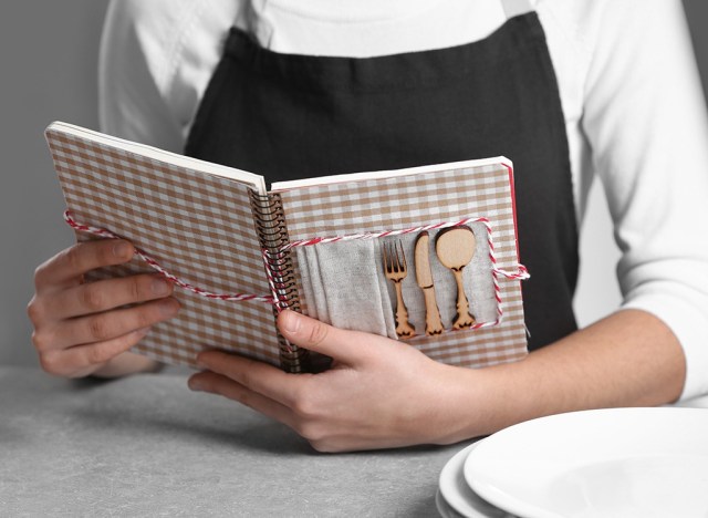 woman holding cookbook